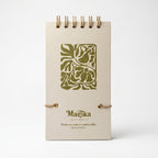 Libreta de notas Trino y Flora vertical con arillo metálico superior, tapa dura mate y elástico
